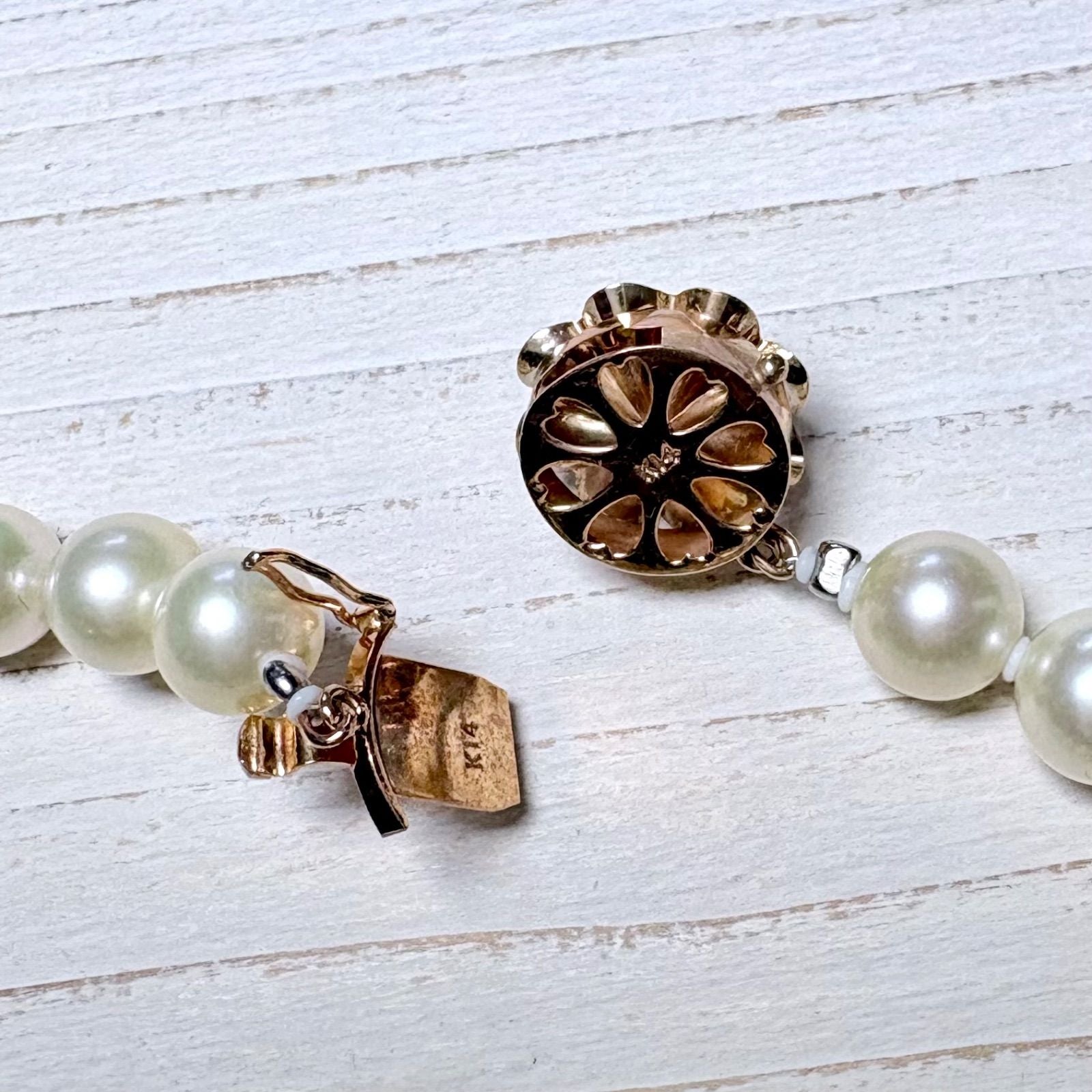 K14 Akoya pearl necklace with 7mm pearls, 127cm long, displayed on a white background