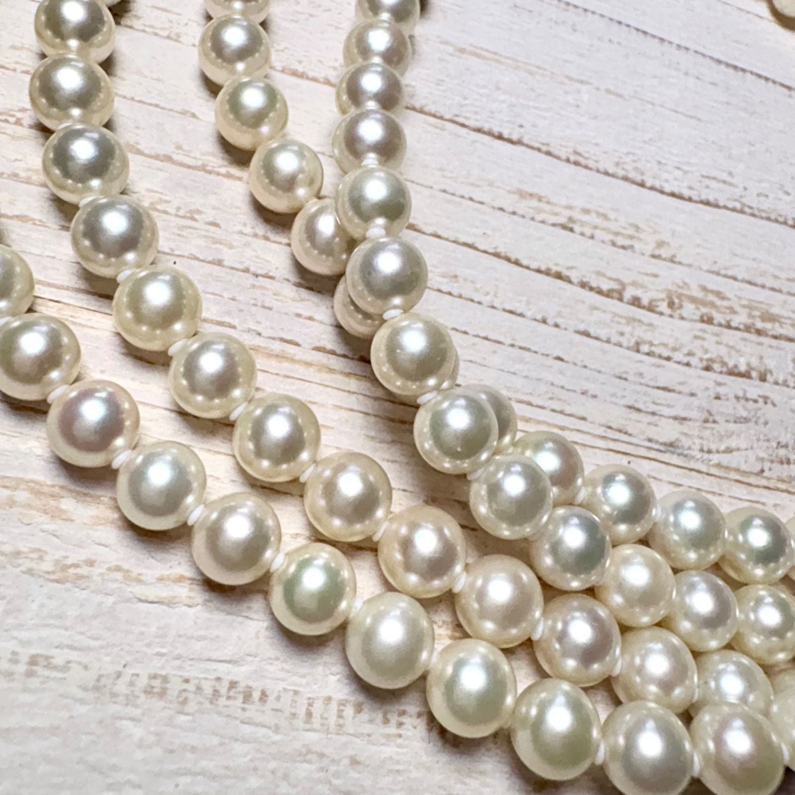 K14 Akoya pearl necklace with 7mm pearls, 127cm long, displayed on a white background