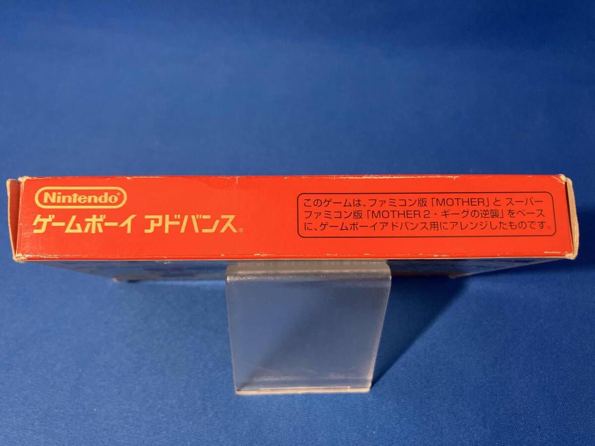 MOTHER1+2 game cartridge with damaged box and manual showing visible scratches and wear