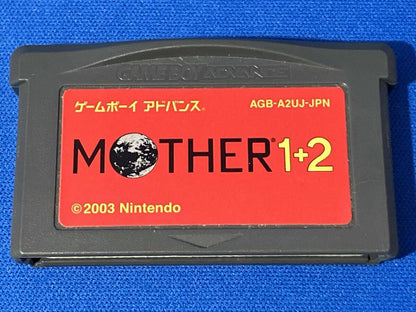 MOTHER1+2 game cartridge with damaged box and manual showing visible scratches and wear