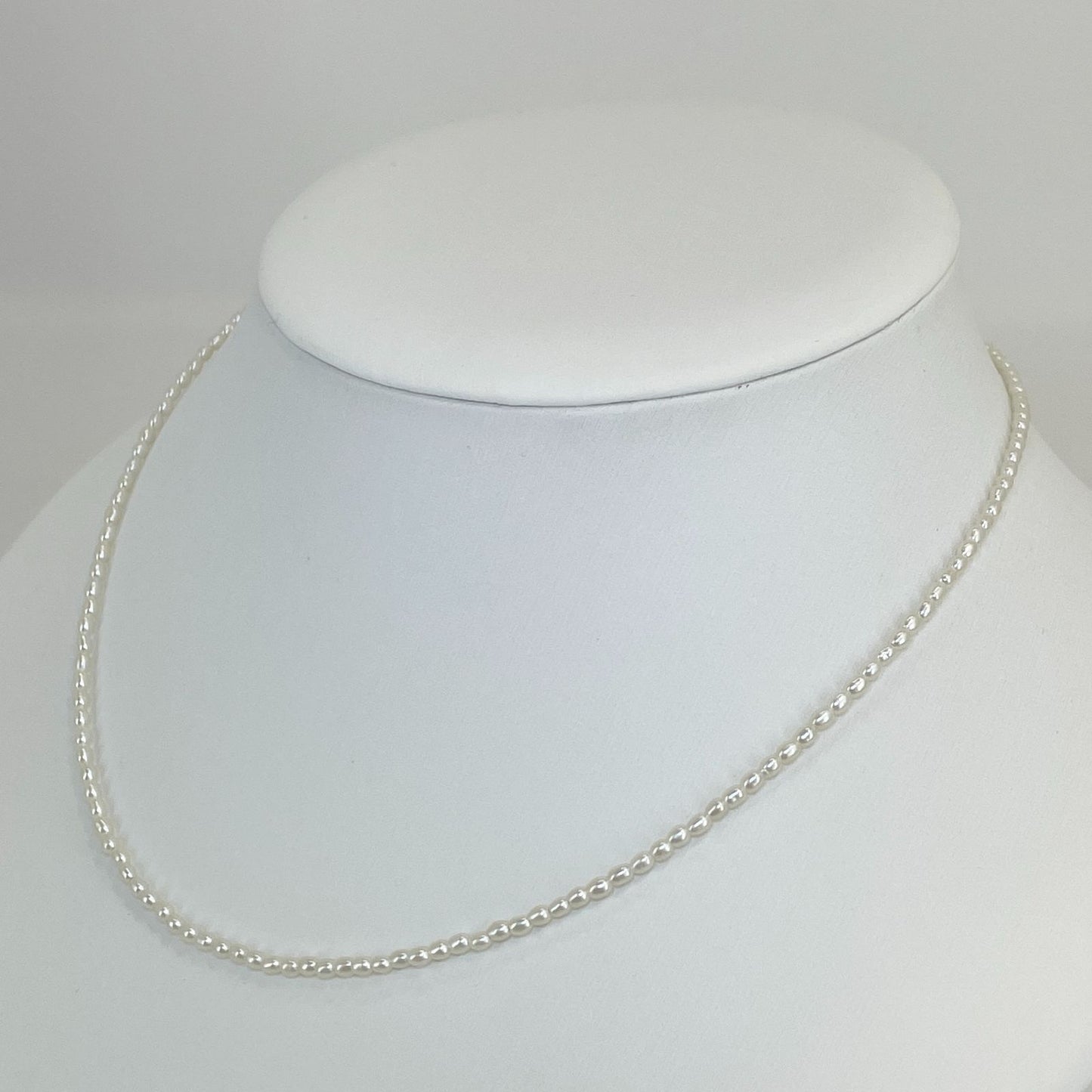 Mikimoto pearl necklace with small freshwater pearls set in K18WG white gold displayed on a white background