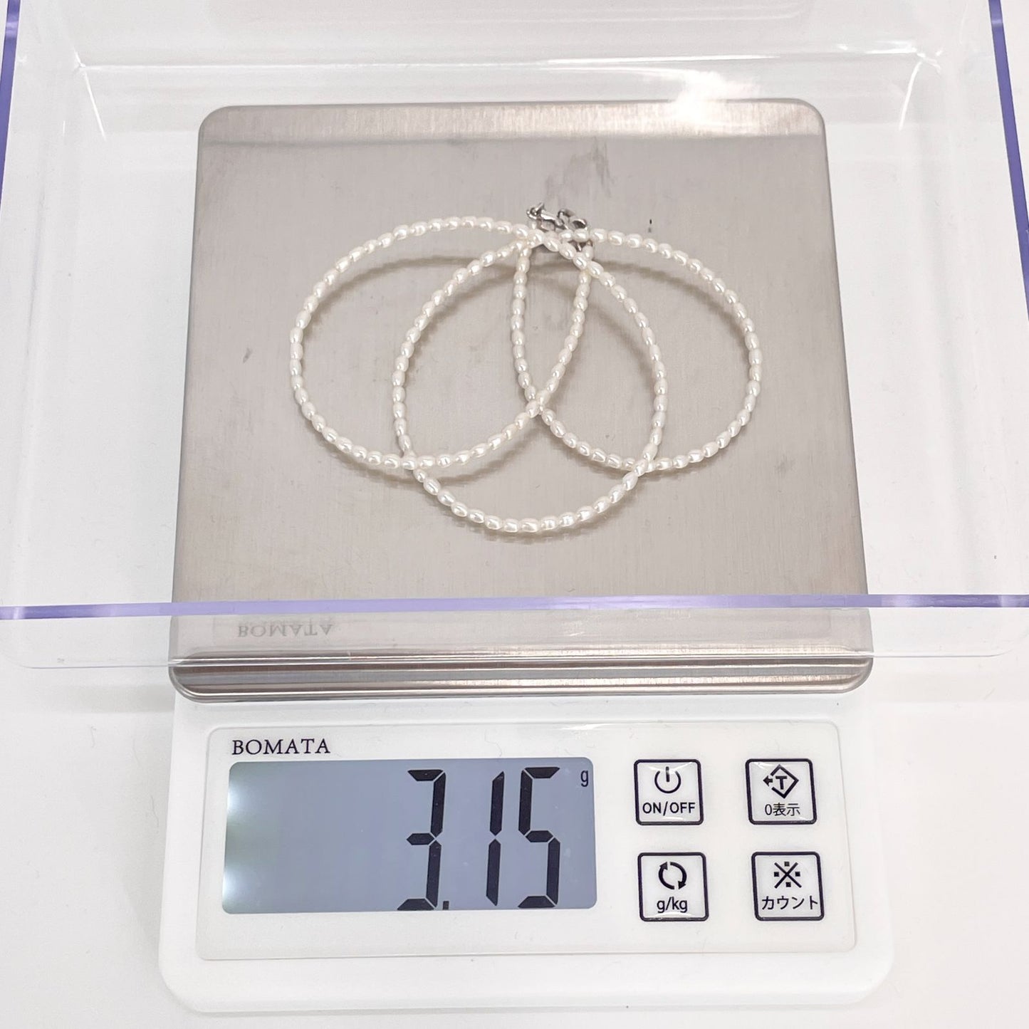 Mikimoto pearl necklace with small freshwater pearls set in K18WG white gold displayed on a white background