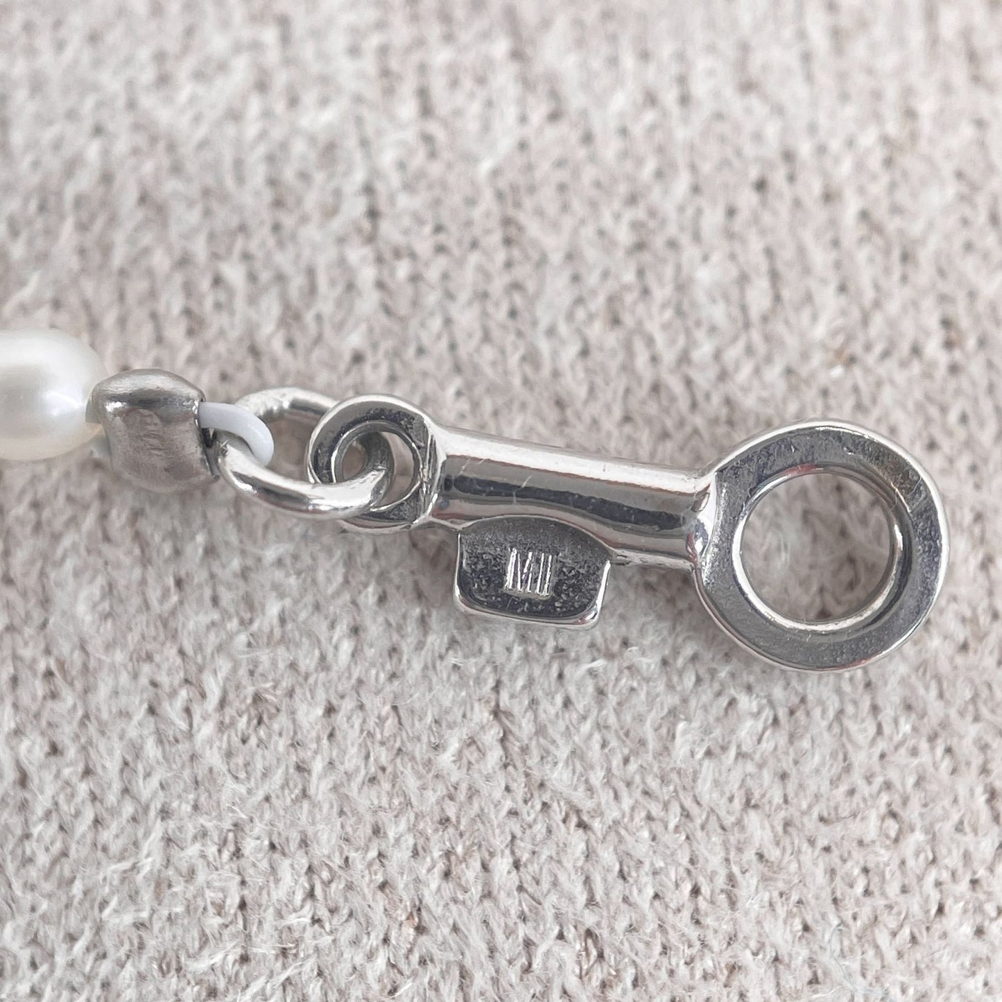 Mikimoto pearl necklace with small freshwater pearls set in K18WG white gold displayed on a white background