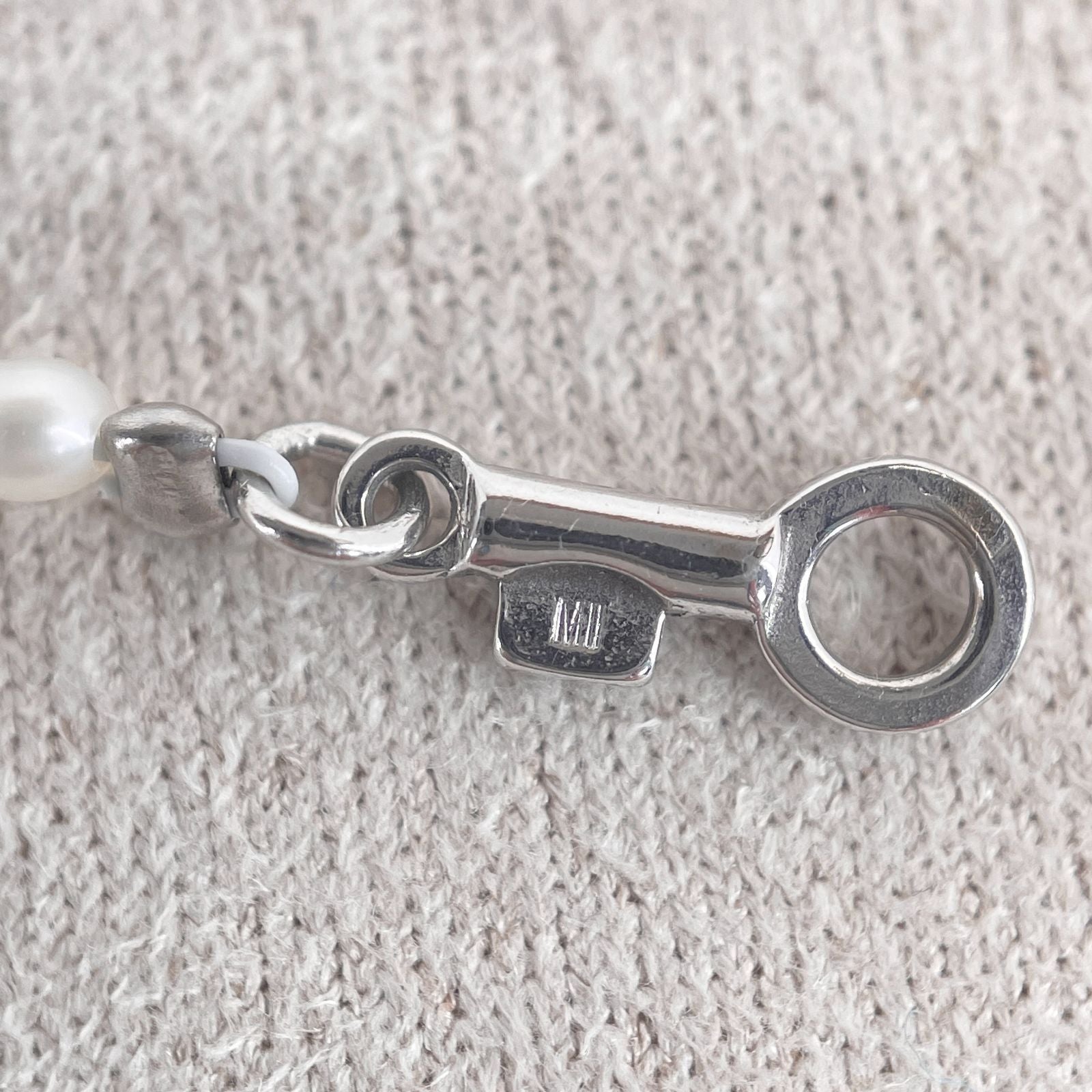 Mikimoto pearl necklace with small freshwater pearls set in K18WG white gold displayed on a white background