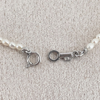 Mikimoto pearl necklace with small freshwater pearls set in K18WG white gold displayed on a white background