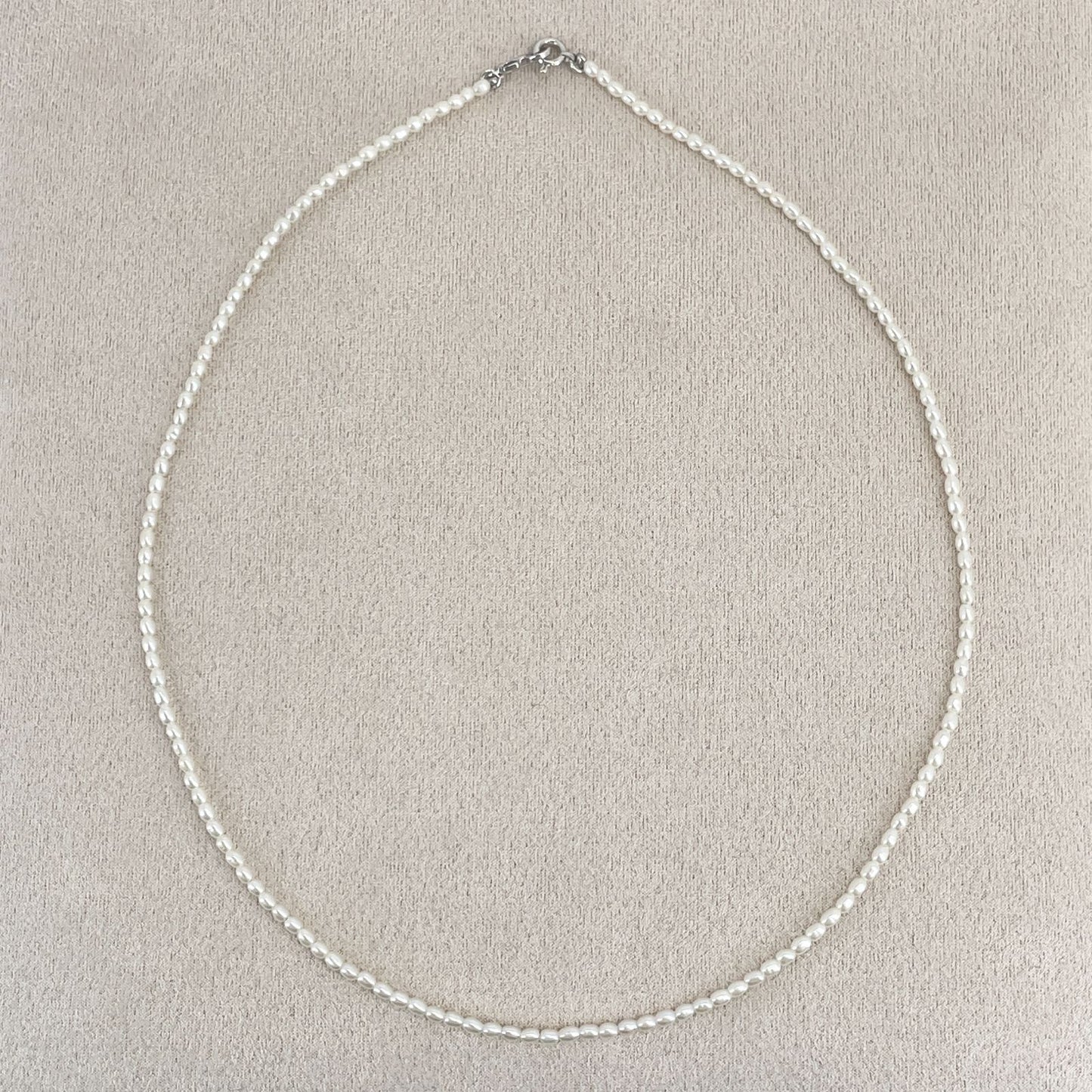 Mikimoto pearl necklace with small freshwater pearls set in K18WG white gold displayed on a white background