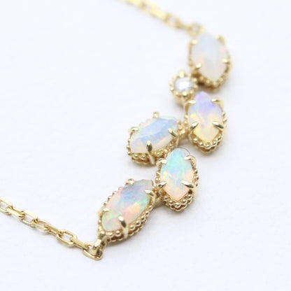 Valuable discontinued agate opal necklace with K18 and K14 gold and diamond accents on 5mm grid background