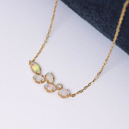Valuable discontinued agate opal necklace with K18 and K14 gold and diamond accents on 5mm grid background