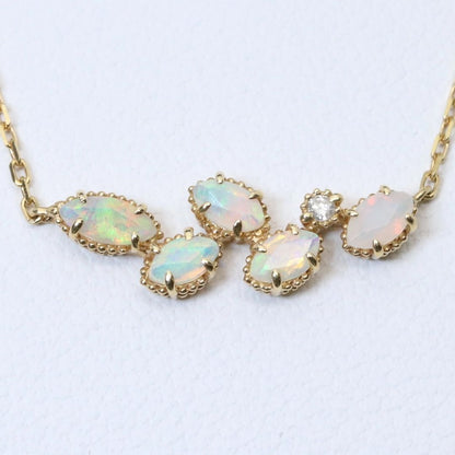 Valuable discontinued agate opal necklace with K18 and K14 gold and diamond accents on 5mm grid background