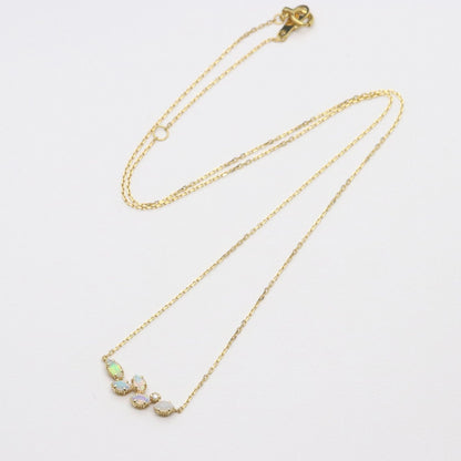 Valuable discontinued agate opal necklace with K18 and K14 gold and diamond accents on 5mm grid background