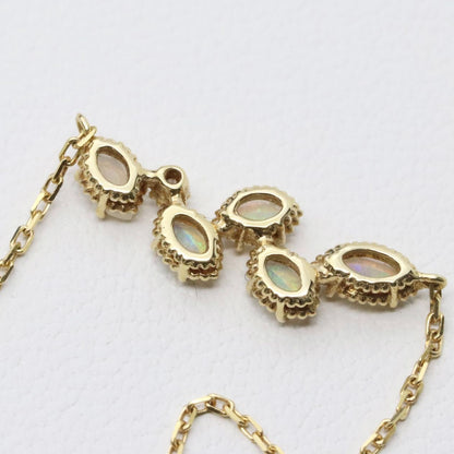 Valuable discontinued agate opal necklace with K18 and K14 gold and diamond accents on 5mm grid background