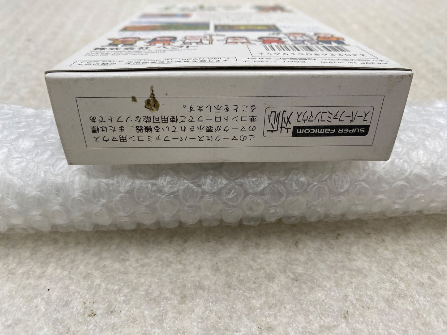 Ihatovo Monogatari Super Nintendo Entertainment System game cartridge with original box showing wear and stains