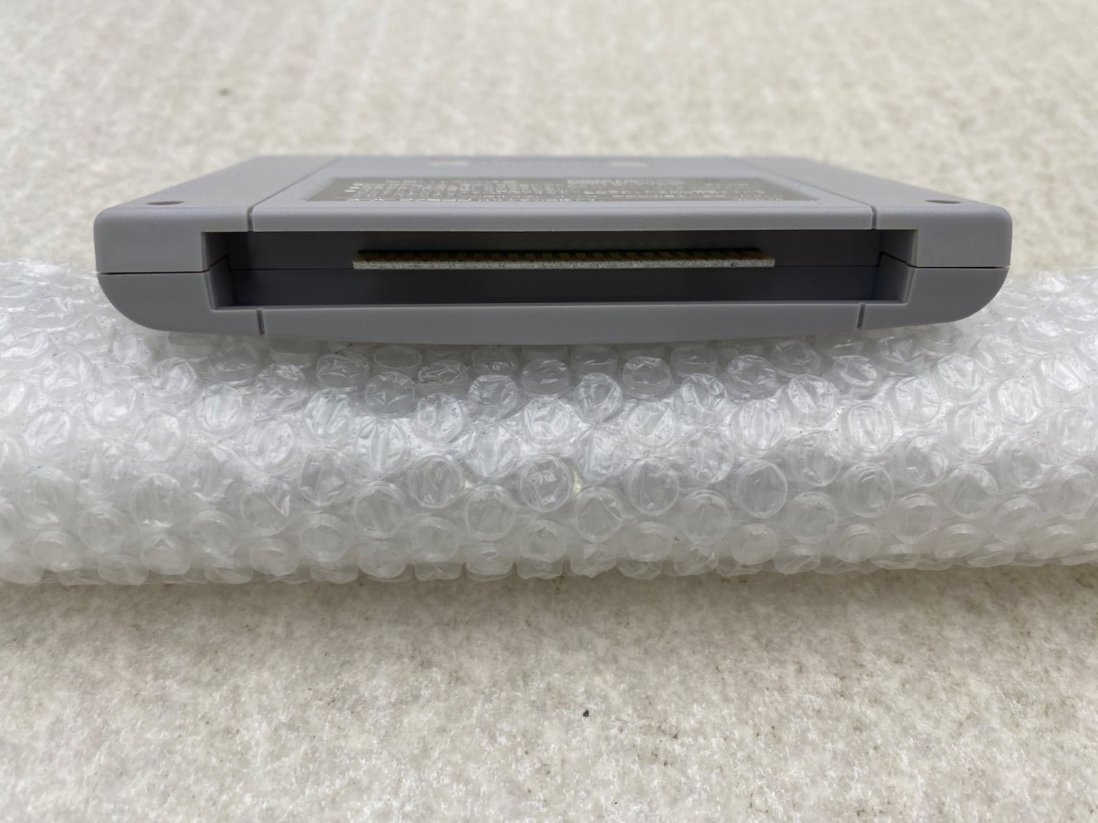 Ihatovo Monogatari Super Nintendo Entertainment System game cartridge with original box showing wear and stains