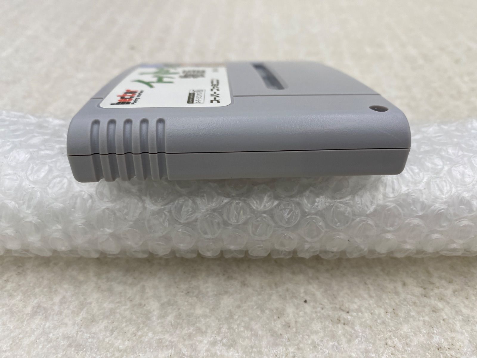 Ihatovo Monogatari Super Nintendo Entertainment System game cartridge with original box showing wear and stains
