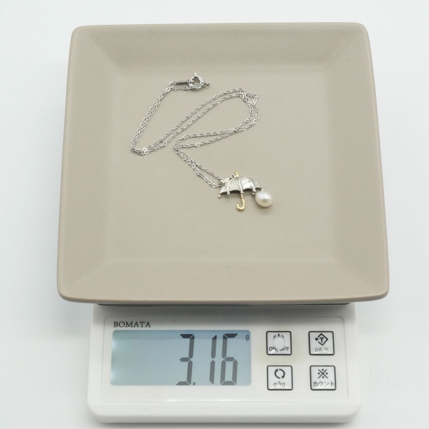 Mikimoto umbrella-shaped necklace in silver and K18 featuring a single pearl