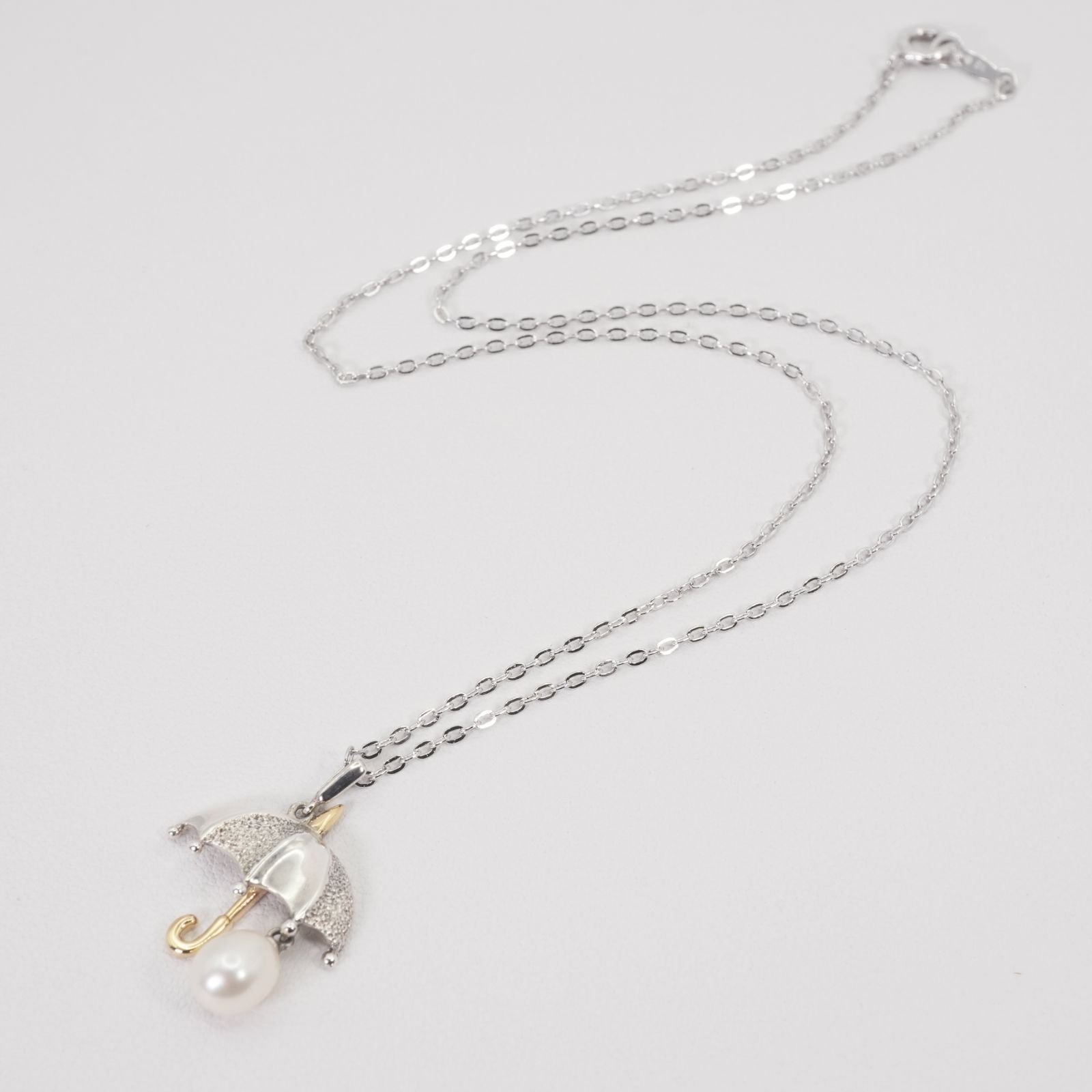 Mikimoto umbrella-shaped necklace in silver and K18 featuring a single pearl