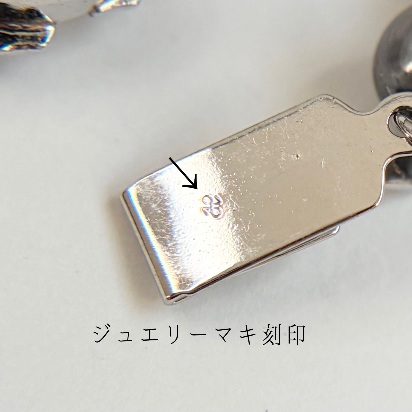 Silver necklace featuring a round black Akoya pearl 6.5-7mm with attached identification card on a 42cm chain