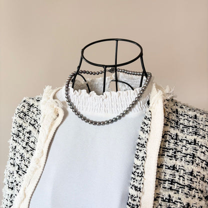 Silver necklace featuring a round black Akoya pearl 6.5-7mm with attached identification card on a 42cm chain