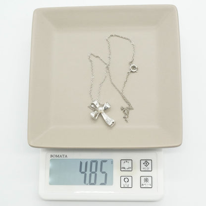 Mikimoto silver necklace with a baby pearl cross pendant, showcasing delicate craftsmanship and polished finish