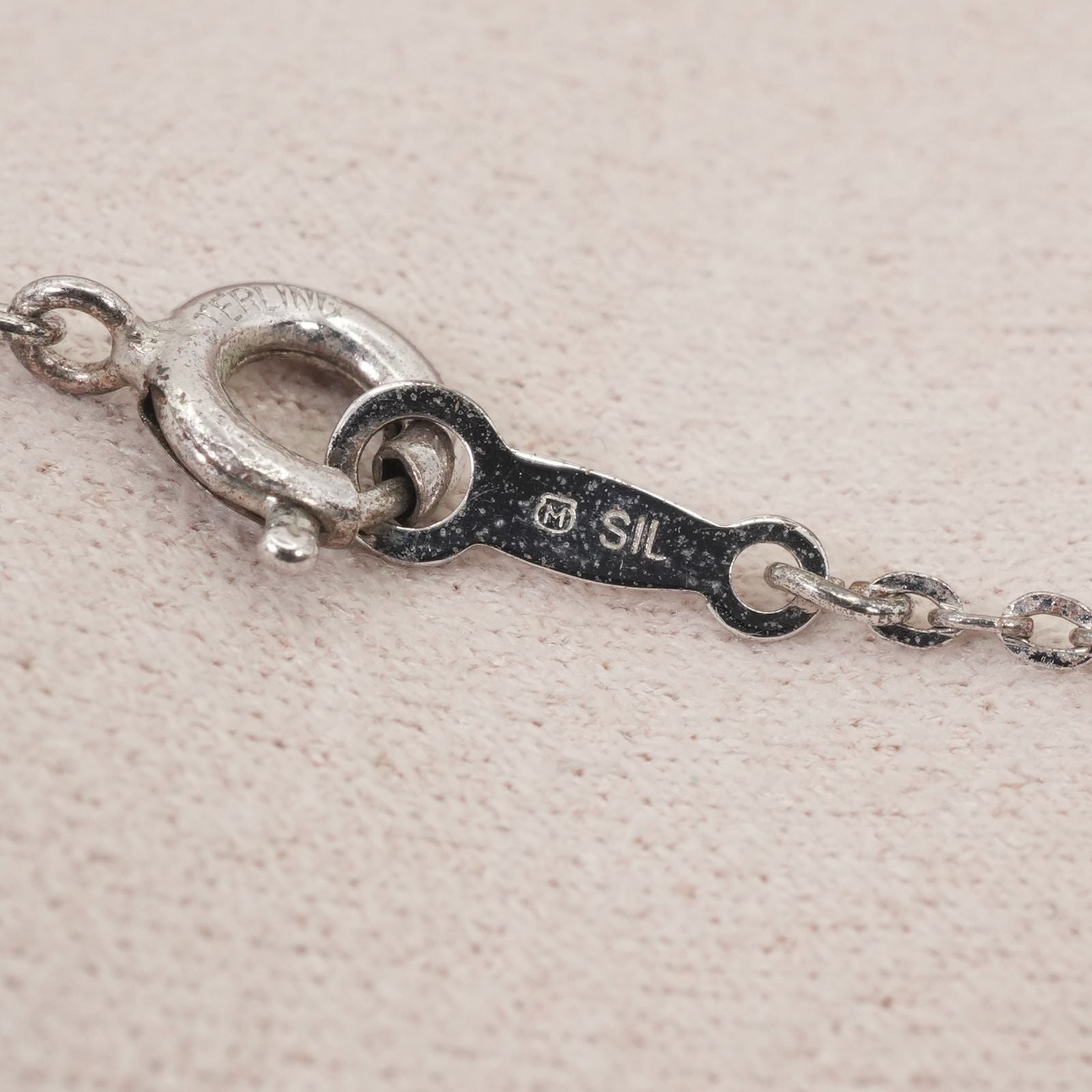 Mikimoto silver necklace with a baby pearl cross pendant, showcasing delicate craftsmanship and polished finish