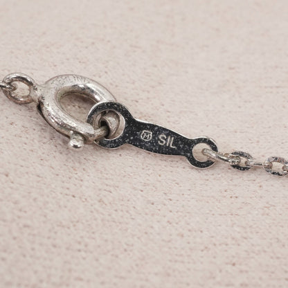 Mikimoto silver necklace with a baby pearl cross pendant, showcasing delicate craftsmanship and polished finish