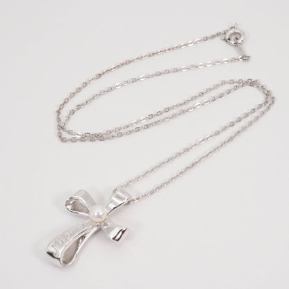 Mikimoto silver necklace with a baby pearl cross pendant, showcasing delicate craftsmanship and polished finish
