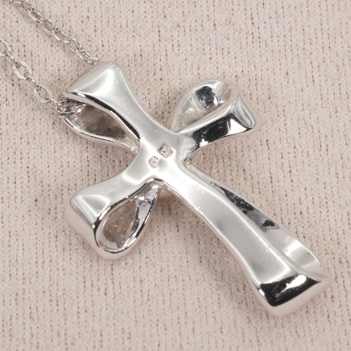 Mikimoto silver necklace with a baby pearl cross pendant, showcasing delicate craftsmanship and polished finish