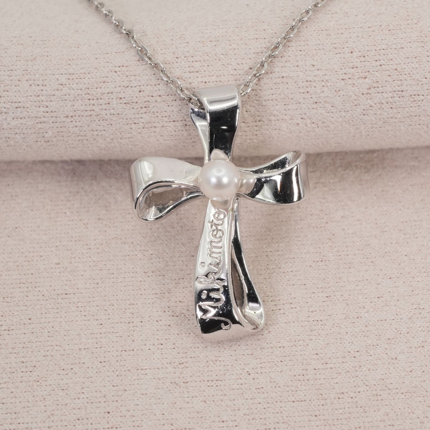 Mikimoto silver necklace with a baby pearl cross pendant, showcasing delicate craftsmanship and polished finish