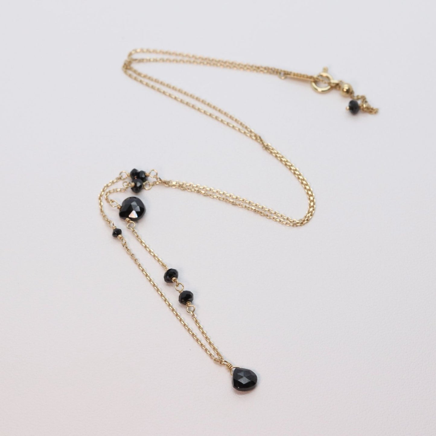 Agete K10 gold necklace with black onyx and slide adjuster on a white background