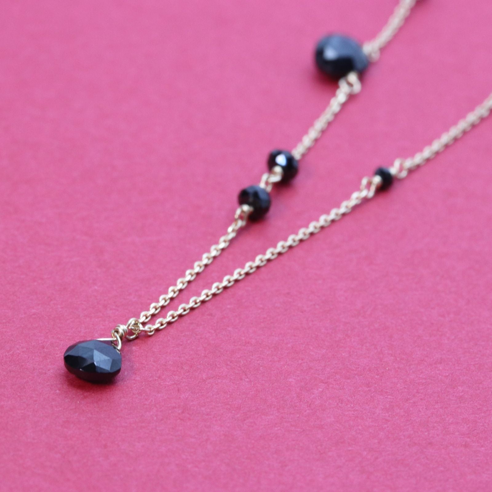 Agete K10 gold necklace with black onyx and slide adjuster on a white background