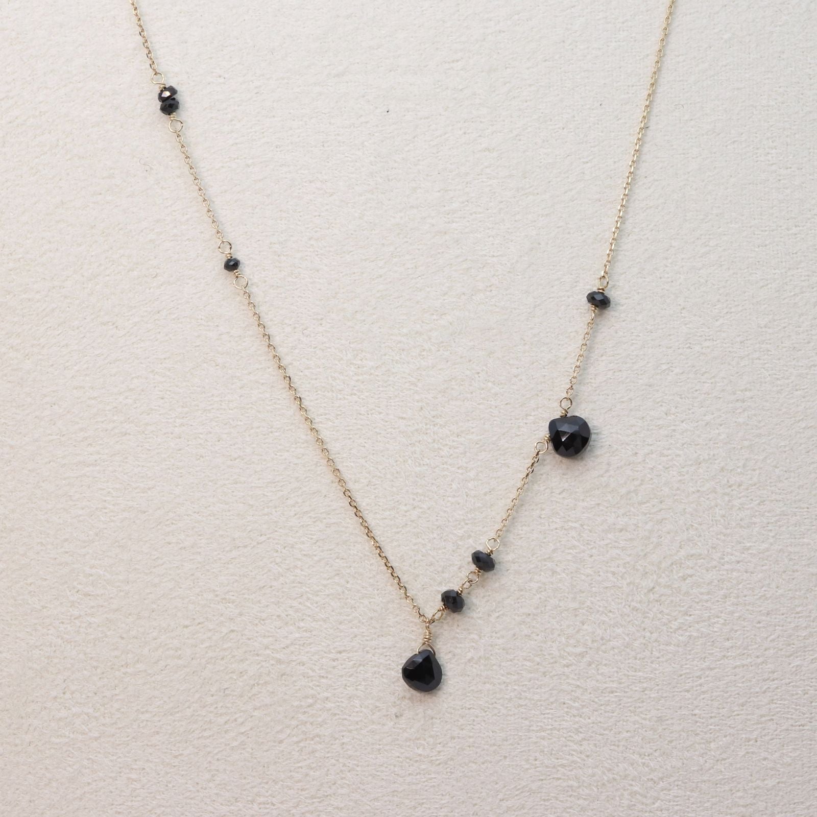 Agete K10 gold necklace with black onyx and slide adjuster on a white background