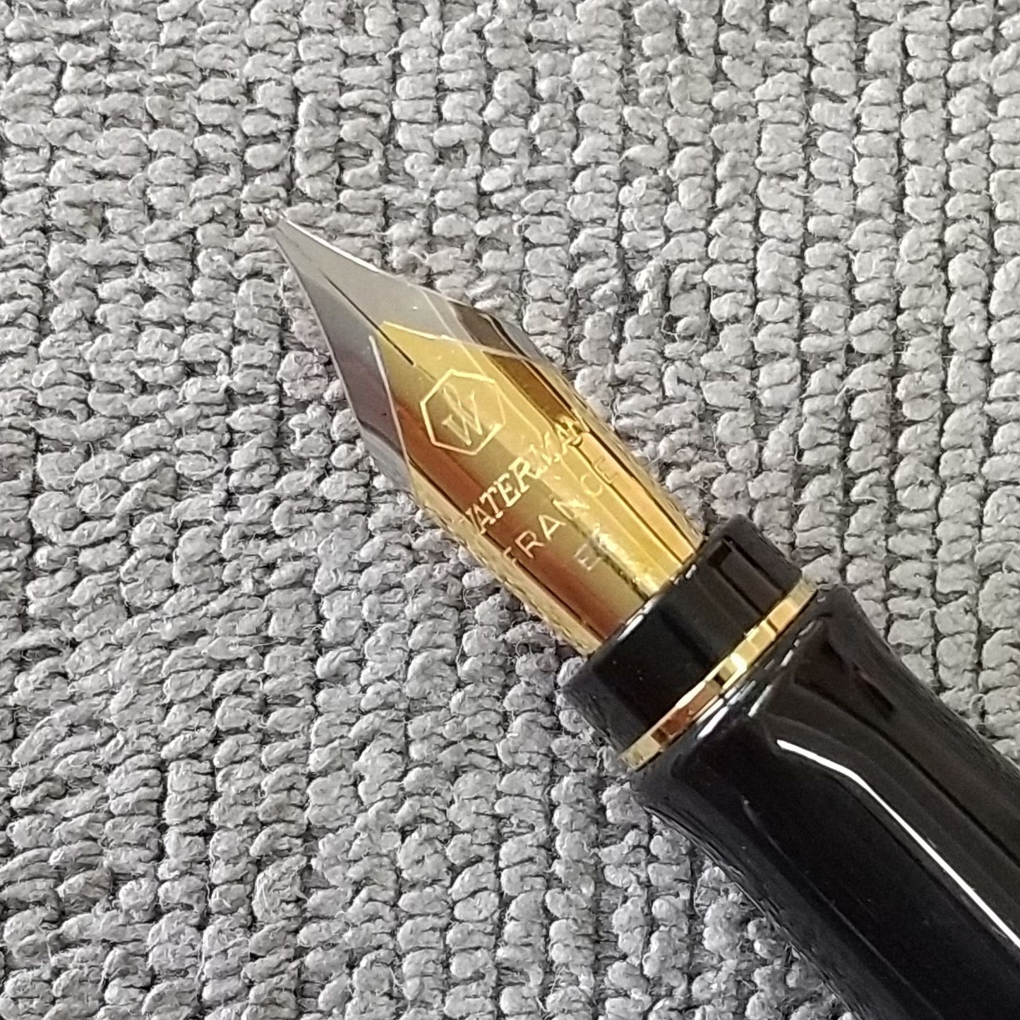 Used Waterman ballpoint pen and fountain pen set showing aged wear and ink residue