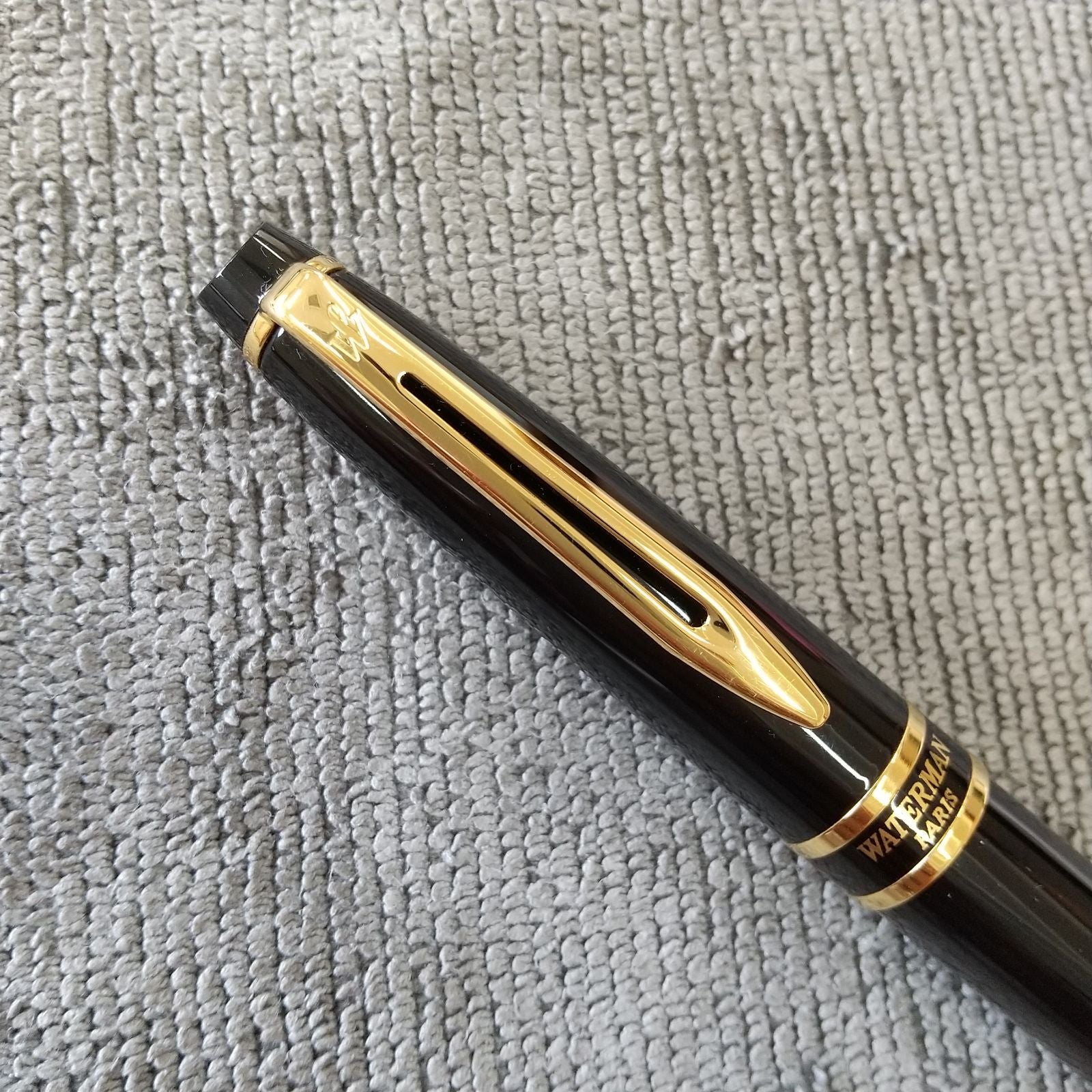 Used Waterman ballpoint pen and fountain pen set showing aged wear and ink residue