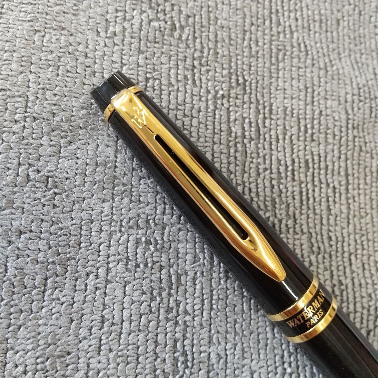 Used Waterman ballpoint pen and fountain pen set showing aged wear and ink residue
