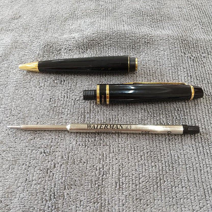 Used Waterman ballpoint pen and fountain pen set showing aged wear and ink residue