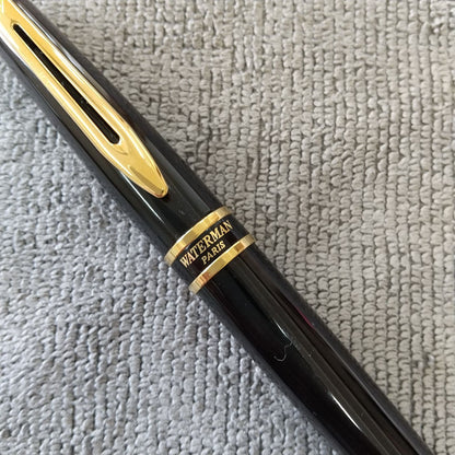 Used Waterman ballpoint pen and fountain pen set showing aged wear and ink residue
