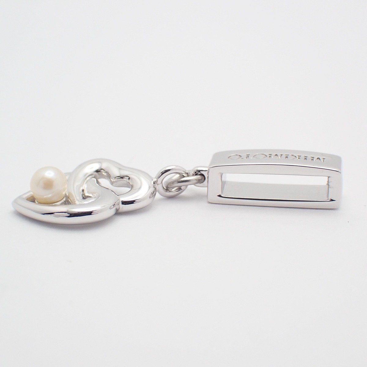 MIKIMOTO Double Heart Pendant made of silver with a pearl, showing front view on white background