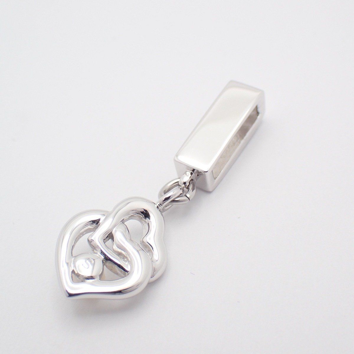 MIKIMOTO Double Heart Pendant made of silver with a pearl, showing front view on white background