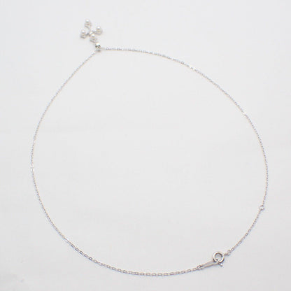 Mikimoto silver cross necklace featuring four small pearls and adjustable chain