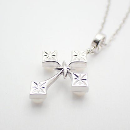 Mikimoto silver cross necklace featuring four small pearls and adjustable chain