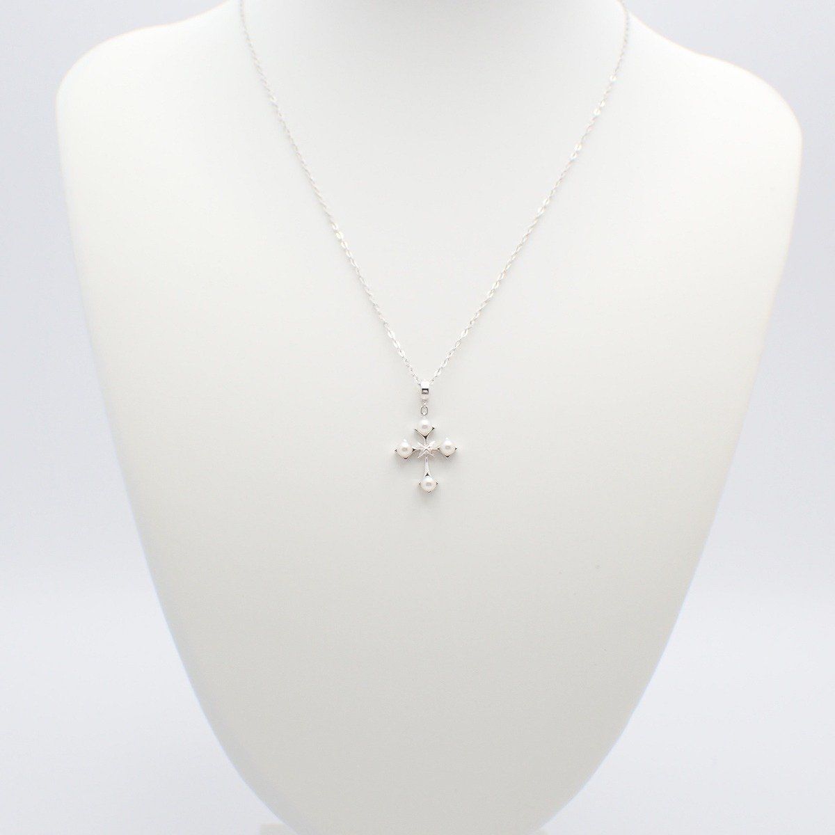 Mikimoto silver cross necklace featuring four small pearls and adjustable chain