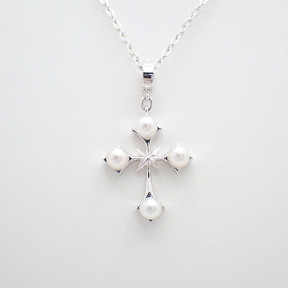Mikimoto silver cross necklace featuring four small pearls and adjustable chain