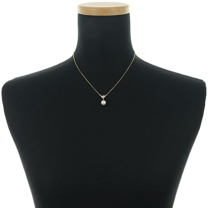 Mikimoto necklace featuring a 7.6mm Akoya pearl pendant with diamond accents set in 18K yellow gold on a 39cm chain