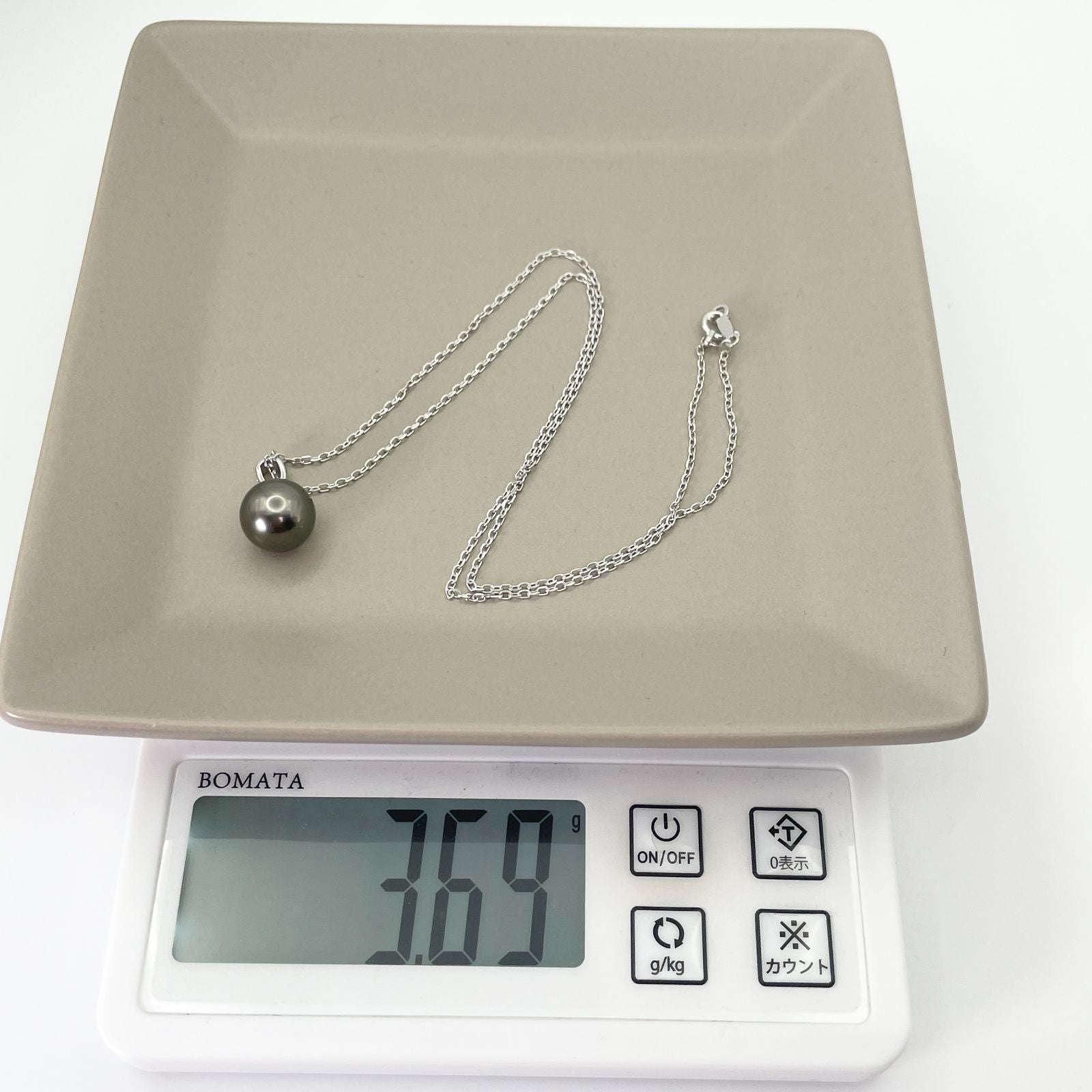 Mikimoto K18WG black cultured pearl necklace model 25-512S on white background