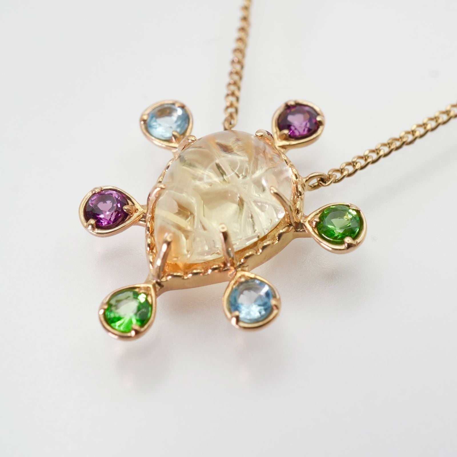 Agete K10 multi-color stone necklace model 24-4457 laid flat showing elegant design