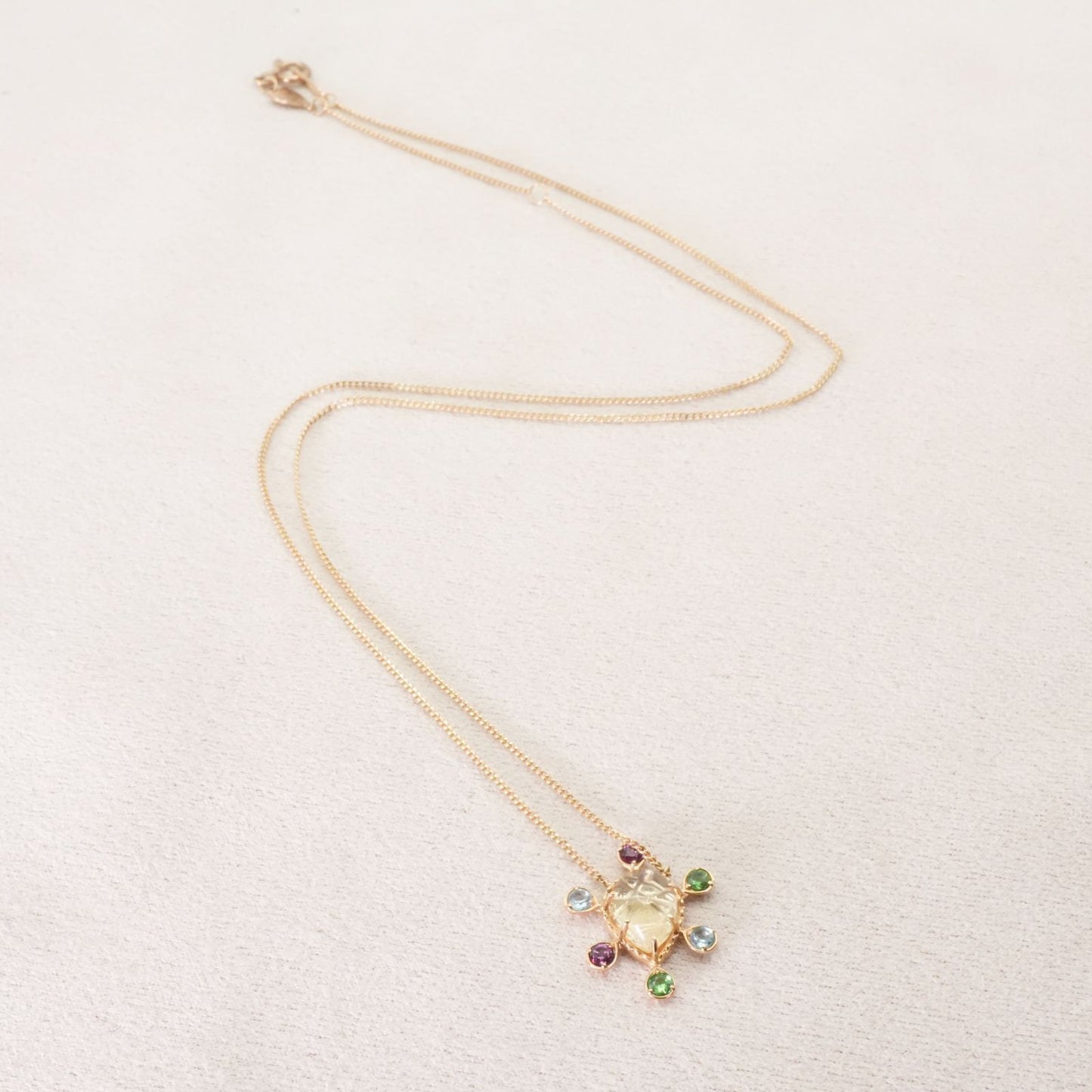 Agete K10 multi-color stone necklace model 24-4457 laid flat showing elegant design