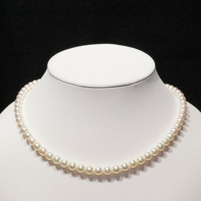 Mikimoto Akoya pearl necklace with 6.4mm pearls and silver current clasp on white background