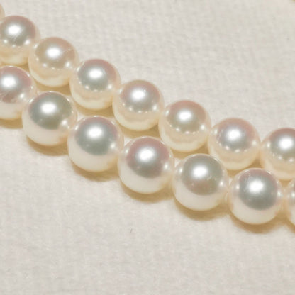 Mikimoto Akoya pearl necklace with 6.4mm pearls and silver current clasp on white background