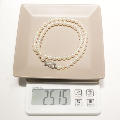 Mikimoto Akoya pearl necklace with 6.4mm pearls and silver current clasp on white background
