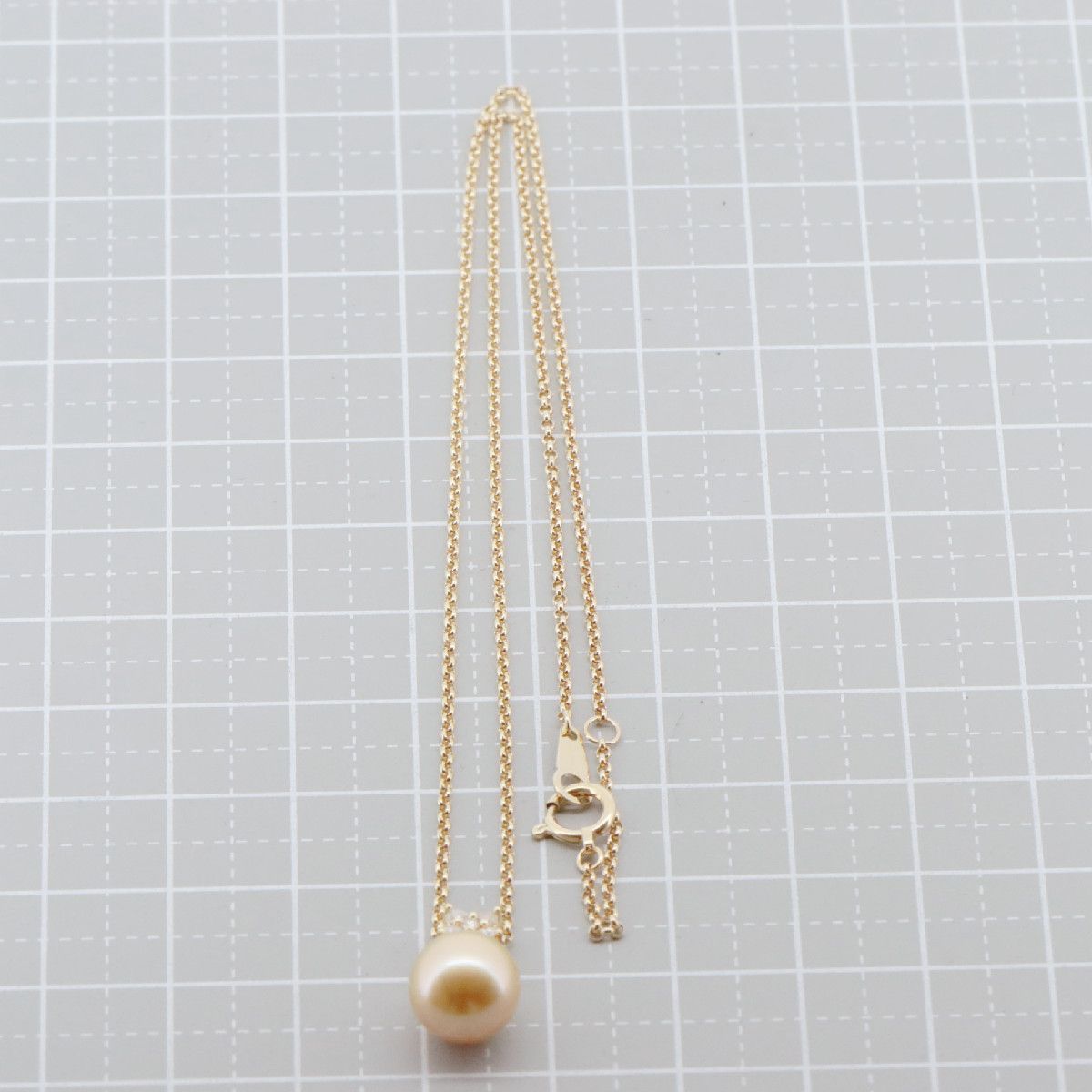 Tasaki Law gold necklace featuring an 8.8mm golden pearl and 0.12ct diamond on an 18K yellow gold chain